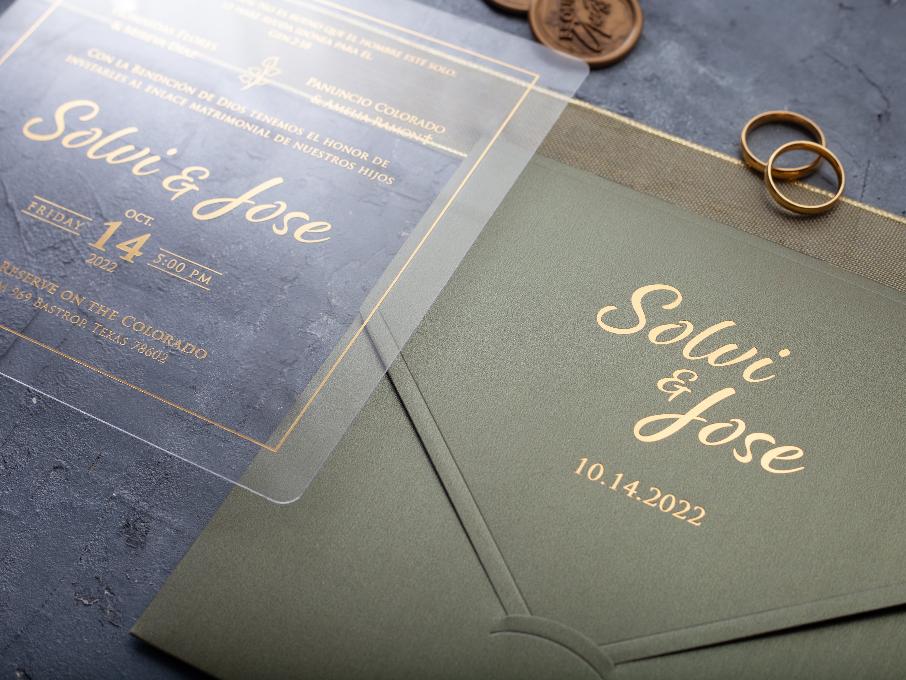 Clear acrylic wedding invitation with gold lettering and sage green envelope by World of Wedding Co.
