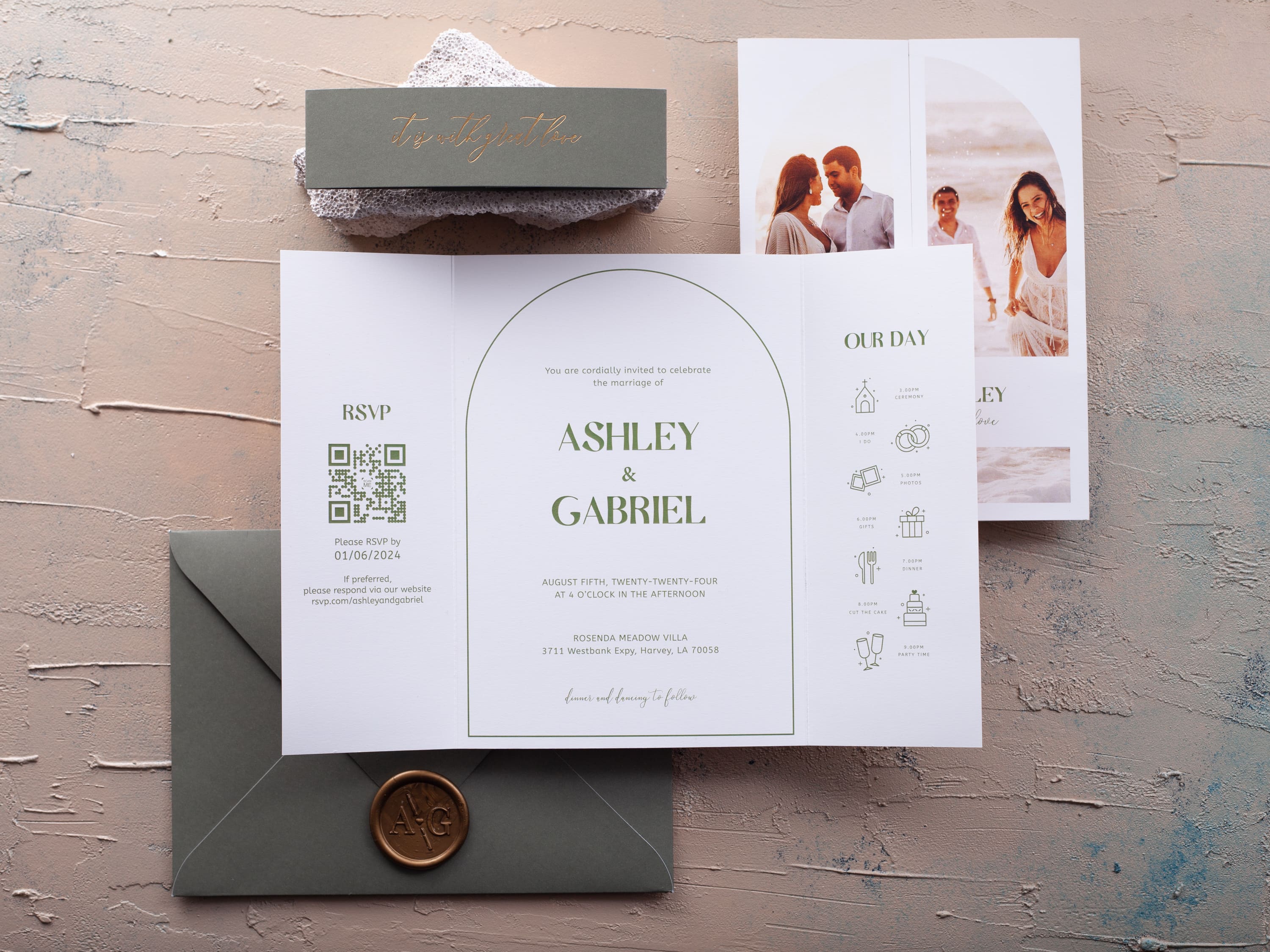 Folded photo wedding invitation with a green belly band and envelope
